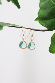 ❀ Aquamarine glass gems and genuine fire opal stones set in gold plated bezels, hung on gold plated ear wires. Opal stones measure 4 x 6mm, peridot glass gems measure 13 x 15mm. Earrings measure approximately 30mm total from top to bottom. ►Please view full collection of ✶E a r r i n g s✶ by clicking the link below: http://www.etsy.com/shop/LuluCrystalline?section_id=12237511 ►Please read my shop ✶P o l i c i e s✶ before purchasing by clicking the link below: http://www.etsy.com/shop/LuluCrystalline/policy ►Feel free to contact me via etsy messages or email if any questions. Thank you so much for visiting Lulu Crystalline! LuluCrystalline 2020. All materials including photos, written material and designs remain the intellectual property of LuluCrystalline. All Rights Reserved. Turquoise Teardrop Faceted Earrings, Turquoise Faceted Teardrop Earrings, Faceted Turquoise Teardrop Earrings, Elegant Faceted Turquoise Earrings, Elegant Turquoise Faceted Earrings, Blue Jewellery, Gold Dangle Earrings, Birthstone Earrings, Glass Gems