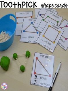 the toothpick shapes are arranged on top of each other, along with two matching cards