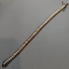 "Sterling Silver Cubic Zirconia Link Bracelet Fine Sterling Silver link bracelet featuring square cut channel set Cubic Zirconia stones. Bracelet has a gold vermeil finish and safety clasp. Bracelet is fully hallmarked and will arrive gift boxed. * HALLMARKS 925. * MEASUREMENTS  7 1/2\" x 5/16\". * WEIGHT 19.87 Grams * CONDITION In very good to excellent condition. Please use pictures as part of item's description. * MATERIALS Sterling Silver, Cubic Zirconia." Classic Gold Tennis Bracelet With Channel Set, Gold Diamond Tennis Bracelet Channel Set, Gold Diamond Channel Set Tennis Bracelet, Gold Channel Set Diamond Tennis Bracelet, Luxury Gold Bracelets With Channel Set, Gold Channel Set Bracelet, Luxury Gold Channel Set Bracelet, Classic Gold Bracelet With Baguette Diamonds, Rectangular Jubilee Bracelet In Cubic Zirconia