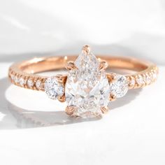 an engagement ring with three pear shaped diamonds