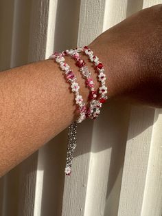 The Beaded Flower Crystal Bracelet is made of quality materials including clear, pink, red, and white shell glass beads and 4mm pink, red, and clear glass crystal beads ✨ - 100% handmade - Premium quality glass Czech beads - Durable transparent nylon thread - Lobster clasp closure with 2in extension chain  You can choose between pink, red, or pink and red and what length you desire your bracelet to be! Please note that orders may take up to a week to ship because all jewelry is handmade ❤️ *Although bracelets are made with the best quality materials, it's still recommended that you avoid contact with moisture and liquids and remove your jewelry before showering or swimming. It's also recommended that you remove your jewelry before exercising, sleeping, or other activities that may cause da Red And Pink Beaded Bracelet, Rose Bead Bracelet, White Beaded Flower Friendship Bracelets, White Flower-shaped Beaded Friendship Bracelets, Red Flower-shaped Beaded Bracelets For Jewelry Making, Adjustable Red Flower Beaded Necklaces, Adjustable Red Flower Beaded Necklace, Red Flower-shaped Beads For Gifts, Red Flower Bracelets For Jewelry Making