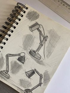 an open notebook with drawings of lamps on it