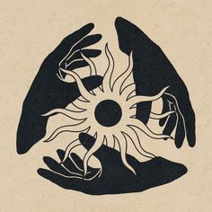 two hands holding an object in the shape of a sun