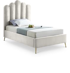 a white bed with an upholstered headboard and foot board on the side