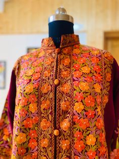 Embroidered Coat , Kashmiri Jacket Description Allow yourself to be lost in the lush flora of Kashmir's enchanted forests every time you wear the Long Kashmiri Jacket. This Kashmiri embroidered jacket is crafted in 100% pure wool/ Pure Raw Silk and . This festival season, you'll be warmed by not just the luxurious fabric but also by our artisans' love for their craft. ● 100% Pure wool / Pure raw Silk ● Crafted in Kashmir ● Traditionally embroidered by our artisans ● Can Also Be Customised In col Intricate Embroidered Nehru Jacket For Winter, Intricate Embroidered Winter Nehru Jacket With Long Sleeves, Embroidered Nehru Jacket With Stand Collar For Fall, Intricate Embroidered Long Sleeve Winter Nehru Jacket, Fall Nehru Jacket With Floral Embroidery And Long Sleeves, Fall Embroidered Nehru Jacket With Stand Collar, Fall Floral Embroidery Nehru Jacket With Long Sleeves, Fall Long Sleeve Nehru Jacket With Floral Embroidery, Traditional Outerwear With Resham Embroidery For Fall