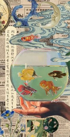 an image of fish in a bowl being held by someone's hand with flowers