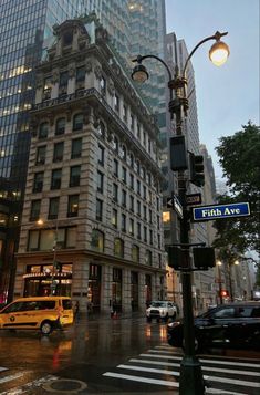 a city street with cars and tall buildings