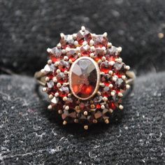 This Is A Beautiful Antique Garnet Cluster Ring Set In 900 Silver. The Ring Has A Tiered Design, And The Top Tier Does Wiggle Some, Though It Is Likely Not At Risk Of Coming Off. Overall, The Piece Is In Very Great Shape And Was Likely Made In The Late-1800s Or Early-1900s. Size Us 5.5 Top Dimensions: 0.75in X 0.6in Classic Red Cluster Ruby Ring, Classic Red Ruby Cluster Ring, Classic Red Cluster Ring, Red Cluster Ring Stamped 14k, Red 14k Stamped Cluster Ring, Heirloom Red Oval Cluster Ring, Classic Red Multi-stone Cluster Ring, Classic Red Cluster Ring For Formal Occasions, Classic Red Cluster Jewelry