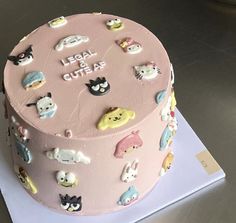 a pink cake with lots of cats on it