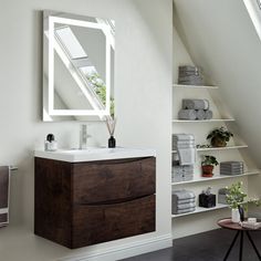 a bathroom with a sink, mirror and shelving unit in the corner next to it