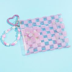 Store your loose change and other small essentials inside this flat pouch! It has pink checkered patterns and a cute print of My Melody harvesting giant flowers. This handy transparent pouch also comes with a special bracelet-like charm made from pastel beads. Features top and bottom snap button closures Comes with a heart-shaped carabiner Pink Square Pouch For Daily Use, Trendy Pink Pouch For Everyday Use, Trendy Pink Pencil Case For Everyday, Trendy Pink Everyday Pouch, Trendy Pink Pouch For Personal Use, Trendy Pink Rectangular Pencil Case, Trendy Rectangular Pink Pencil Case, Pink Square Pouch For Gift, Handmade Pink Rectangular Pencil Case