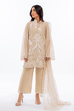 An ethereal sand coloured khaddi corduroy shirt is rendered with bold ivory dori embroidery. Eyelet details on scalloped edges are featured on the shirt as well as on the matching organza dupatta. Complete the look with our signature rawsilk culottes accented with embroidered details. Organza Punjabi Suits, Casual Kurtis For Women, Culottes Outfit Indian, Elegant Beige Sharara With Intricate Embroidery, Elegant Cotton Silk Palazzo Set With Chikankari Embroidery, Cream Organza Sets With Intricate Embroidery, Elegant Beige Palazzo Set With Intricate Embroidery, Elegant Embroidered Beige Sharara, Festive Beige Lace Work Sets