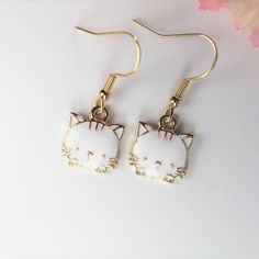 ♥ Best Christmas White Cat Earrings Cute Cat Charm Pet Gift Animal Charm Love Cat Gift Cute Kitty Gift Birthday Gift Personalized Gift ♥ This is Beautiful Gold White Cat Earrings Charm on ear hook ♥ You will receive 1 pair ♥ Alloy Charm Cat Plated Light Gold White Enamel Lead & Nickel Free about : 15x13x3 mm **Conversion : inch 25.4mm or 1mm =0.0393 inches ♥ ear hook 19 mm ♥ We strive for next day shipping, but we do not ship on Saturdays, Sundays, and Holidays. It may sometimes take a bit l Cute Cat Print Jewelry Gift, Cute Cat Design Earrings For Gift, Cute Cat Design Earrings As Gift, White Cat Design Jewelry With Cat Ears, Novelty White Cat Design Jewelry, Cute White Jewelry With Cat Design, Cute White Cat Ears Jewelry, Cute White Cat Design Jewelry, Novelty Cat Ears Jewelry Gift