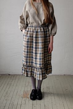 Victorian style inspired ruffle petticoat skirt is made from 100% soft and washed linen. This Petticoat is perfect for wearing under dress or other skirt or can be worn alone. Match it with our tunics! Details: - Composition: 100% Oeko-Tex certified linen - Colour: Natural/brown/Blue plaid - Pockets - Elastic waist - Size: One size/fits all - Medium weight linen - Linen care: machine wash gentle; tumble dry low, ironing optional - The price is for one skirt, other pictured items are not included Fitted Peasant Skirt With Lining, Cottagecore Flowy Gathered Skirt, Cottagecore Gathered Flowy Skirt, Peasant Cotton Skirt With Ruffles, Cottagecore Full Skirt With Fitted Waist, Cottagecore Full Skirt Fitted At Waist, Cottagecore Fitted Full Skirt, Fitted Cottagecore Full Skirt, Fitted Full Skirt In Cottagecore Style