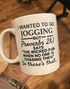 a person holding a coffee mug with the words i wanted to go jogging but provers say they'd run when no one is chasing them so there's that