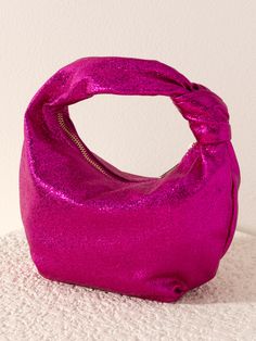 Give your winter accessories a chic update with Shiraleah’s Chrissy Metallic Velvet Top Handle Bag. This petite handbag is made from textured metallic PU giving its vibrant magenta color a trendy and unique shimmer. With its unique top handle silhouette featuring an elegant knot detail, it is the perfect accessory to add to any outfit. Pair with the matching Metallic Knotted Headband or other items from Shiraleah to complete your look! Shiraleah is a trend-driven lifestyle brand focused on the l Chic Purple Shoulder Bag For Party, Glamorous Pink Bag For Everyday Use, Glamorous Pink Bags For Everyday Use, Pink Party Bag With Zipper Closure, Pink Party Shoulder Bag With Zipper Closure, Pink Party Shoulder Bag With Zipper, Party Tote Bag With Zipper Closure, Purple Party Tote Shoulder Bag, Trendy Evening Bag With Zipper Closure For Party