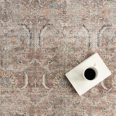 a coffee cup sitting on top of a rug