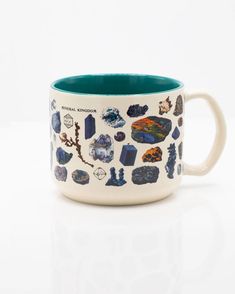 a ceramic mug with various rocks and seaweeds on the inside, sitting on a white surface