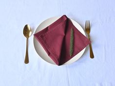 a white plate topped with a napkin and fork