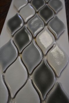 a white and gray mosaic tile on a table