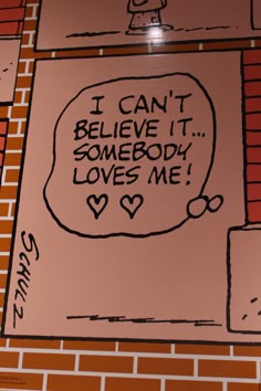 a sign on the wall that says i can't believe it somebody loves me