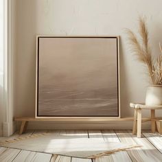 an empty room with a wooden floor and a large painting on the wall above it