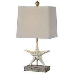 a starfish lamp with a white shade on it