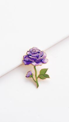 "Add a touch of enigma to your ensemble with our exquisite Purple Rose Enamel Pin. Throughout history, the purple rose has been a symbol of enchantment, fascination, and the mysteries of love. This pin, with its lush lavender and deeper purple shades, is a celebration of love's deeper, more mysterious layers. Symbolism & Uses: Enchantment: A purple rose is known to convey enchantment and a deep magnetism. Mystery and Love: Representing the complexities and depths of love, a purple rose stands fo Lavender Flower Brooch For Gift, Flower Shaped Enamel Pin For Gift, Rose Flower Brooch Gift, Rose Gold Flower Brooches As Gift, June Birth Month Flower, Flower Lapel, Lapel Brooch, Purple Shades, Flower Lapel Pin