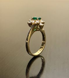 DeKara Designs Classic Handmade Art Deco Oval Emerald and Diamond Ring. This ring was entirely handmade by my father in the 1980's, anyone lucky enough to buy this ring will truly appreciate the workmanship and the beauty of this piece of art. Metal- 14K Yellow Gold, .583 Stones- 1 Oval Natural Green Emerald 0.45 Carats, 10 Round Diamonds, G-H color VS1 Clarity, 0.50 Carats. This ring is entirely put together piece by piece, and all the stones are carefully and expertly prong set. The ring is a Heirloom Emerald Ring Stamped 14k, Heirloom 14k Stamped Emerald Ring, Vintage Emerald Ring In Yellow Gold With Brilliant Cut, Traditional Gold Emerald Anniversary Ring, Heirloom Emerald Ring With Halo Setting, Vintage Yellow Gold Emerald Ring With Halo Setting, Vintage Gold Ring With Halo Setting, Vintage Halo Ring With Center Stone, Vintage Emerald Ring With Brilliant Cut