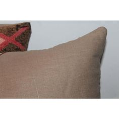 two brown pillows with red crosses on them