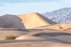 the desert is filled with sand dunes and mountains