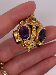 Vintage 18k yellow gold talisman pendant with amethyst and multi color gemstones. There are 5 bezel set amethyst gemstones that measure about 11 x 9mm. There are 2 pink tourmaline, 2 green tourmaline, and 1 citrine set in bezels around the top. The charm weighs 21.48 grams of gold. Luxury Amethyst Multi-stone Jewelry, Luxury Multi-stone Amethyst Jewelry, Luxury Multi-stone Purple Jewelry, Luxury Purple Multi-stone Jewelry, Luxury Gold Multi-stone Gemstones, Gold Multi-stone Gemstones, Gold Luxury Amethyst Multi-stone Ring, Unique Multi-stone Gold Gemstones, Luxury Gold Amethyst Multi-stone Ring