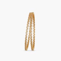 Description: This stackable bangle features glistening round CZ stones that grace the wrist with an aura of light. Just slip them on casuals for everyday fashion. Details & Specifications: Materials used: CZ stones with Yellow and White Gold Plating Weight - 32 gm Length - 2.6- 2.375 cm, 2.8- 2.5 cm Make it custom Want to make it a custom bangle? Sure! Reach out to us at support@tarinika.com and we’ll be happy to make possible modifications at no extra cost. Feel free to write to us on the same Cz Bangles, Custom Bangle, Stackable Bangles, Gold Polish, Cz Stone, Gold Bangles, Fashion Details, Jewelry Trends, Gold Plating