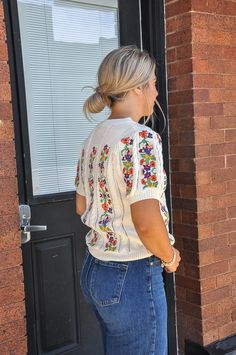 The Flower Embroidery Pointelle Short Sleeve Sweater is a delightful blend of delicate craftsmanship and feminine style. This sweater is distinguished by its intricate pointelle knit pattern, which creates a lacy, openwork effect that is both breathable and visually appealing. The lightweight material makes it a perfect choice for transitioning between seasons. The standout feature of this sweater is the exquisite flower embroidery that adorns the fabric. The floral designs are carefully stitche White Floral Embroidery Sweater For Spring, White Sweater With Floral Embroidery For Spring, Spring Crew Neck Open Knit Crochet Top, Floral Embroidery Knit Tops For Fall, Knit Tops With Floral Embroidery For Fall, Fitted Bohemian Crochet Crew Neck Top, Spring Crew Neck Open Knit Top, Spring Open Knit Crew Neck Top, Bohemian Crochet Lace Crew Neck Sweater