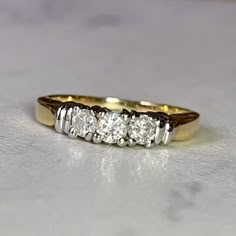 a five stone diamond ring sitting on top of a table