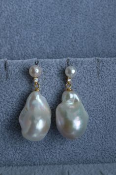 Indulge in the captivating femininity of our double baroque pearl sterling silver dangle earrings, designed to elevate your special occasion with an enduring sophistication. With a delicate 7 mm round pearl accented by petite CZ stones for a hint of sparkle, and a larger dangling white baroque pearl, these earrings epitomize the essence of bridal elegance. Allow theese earrings to accompany you exquisitely, as the baroque pearl sways gracefully with your every step, bestowing a dash of charm to High Luster Drop Pearl Earrings For Anniversary, High Luster Drop Earrings, Silver Drop Earrings With High Luster, Exquisite High Luster Silver Earrings, Silver Dangle Pearl Earrings With High Luster, High Luster Pearl Drop Earrings, Anniversary Teardrop Pearl Earrings With High Luster, Silver High Luster Drop Pearl Earrings, Pearl White High Luster Drop Earrings