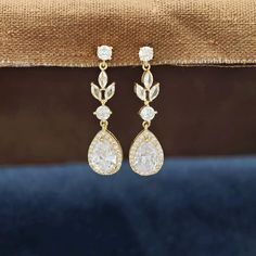 Sparkling Cubic Zirconia Floral Teardrop Earrings, a perfect accessory for the bride-to-be, bridesmaids, or anyone seeking a sophisticated touch of elegance for their special day or any occasion. These bridal earrings are designed to captivate with their high-quality cubic zirconia stones, set in a floral teardrop pattern that exudes timeless grace. ✨ Key Features: - Earring Length: Approximately 1.57 inches, making them the perfect length for a variety of hairstyles and face shapes.  - Bottom T Teardrop Pattern, Bridal Earrings Gold, Earrings For Wedding, Wedding Day Jewelry, Gold Bridal Earrings, Bride Earrings, Earrings Bridesmaid, Stunning Earrings, Gold Earrings Dangle