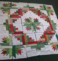 a quilted table topper made with red, green and white squares on it