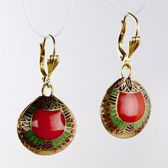 This over 3000 year old design is work of timeless elegance. An exact replica of an ancient Egyptian design from the Egyptian Museum of Cairo, these enamel on copper cloisonné earrings depict abstracted scarabs in a beautifully detailed geometric design. Silver lever- backs ear wires for pierced ears. Size 1 1/2 Inches tall. Red Artistic Drop Earrings, Artistic Metal Drop Earrings, Red Round Ceremonial Earrings, Artisan Red Jewelry With Artistic Design, Red Enamel Traditional Earrings, Traditional Red Enamel Earrings, Traditional Red Oval Earrings, Traditional Oval Red Earrings, Artisan Red Brass Jewelry