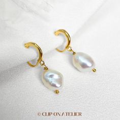 * Style: Minimalist, Classy, Elegant * Material: Gold-plated brass, Freshwater Baroque Pearls (natural pearl, each is unique) * Dimension:  Approximate overall length: 2.2 cm-2.8 cm.  * Please note that the size and shape of the pearls vary from pair to pair. *  * ❀ *  * ♥ ♥ How to wear coil pad clip-on earrings?  All you have to do is slip the clip-on onto your earlobe, press the coil pad and it will stay. ❗️❗️For wearing tips, please go to the "About" section, we've filmed a video for how to w Pearl Huggie Earrings For Wedding, Gold Hoop Bridal Earrings With Pearl Drop, Elegant Brass Dangle Huggie Earrings, Gold Hoop Pearl Earrings For Wedding, Gold Plated Hoop Earrings With Ear Wire For Wedding, Delicate Gold Hoop Earrings For Wedding, Delicate Yellow Gold Huggie Earrings For Wedding, Gold Plated Hoop Earrings With Pearl Charm For Wedding, Huggie Pearl Hoop Earrings For Wedding