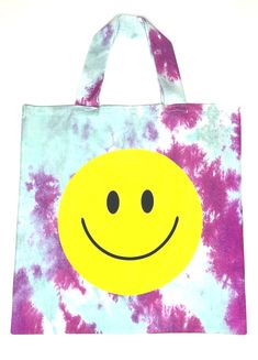 Your carry-all this spring/summer! The LoveHappy Smiley Printed Tote is a 100% cotton tote with a smiley face front and back. Each tote has an inner lining for durability. Features: 100% Cotton printed Smiley tote 19.5” x 19.5” 10” Drop handle Step Daughter, Turquoise And Purple, Print Tote, Cotton Totes, Smiley Face, Make And Sell, Smiley, Reusable Tote Bags, Spring Summer