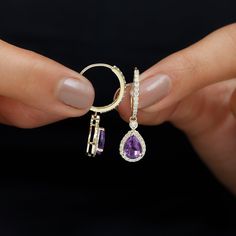 Product Details Complete your look with this elegantly designed Amethyst Teardrop Earrings. These Hoop Drop Earrings are crafted with Gold and adorned with Pear Shape Amethyst in Prong Setting and Round Diamond set in Halo to make for a lovely choice for different occasions. These Amethyst and Diamond Earrings and your love make her eyes glitter. Product Information SKU SHP-EARRINGS112115438 Length 24.9 mm Width 8.2 mm Height 12 mm Weight 3.24 gm (Approximate) AMETHYST INFORMATION No.of Stones 2 Elegant Purple Round Hoop Earrings, Elegant Purple Hoop Earrings, Gift Amethyst Teardrop Earrings, Elegant Purple Pierced Hoop Earrings, Adjustable Teardrop Amethyst Earrings, Elegant Amethyst Dangle Hoop Earrings, Elegant Purple Amethyst Hoop Earrings, Luxury Teardrop Amethyst Earrings, Elegant Purple Gemstone Hoop Earrings