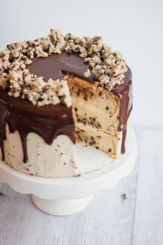 a cake with chocolate frosting and nuts on top