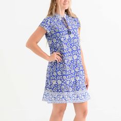 This Jaipur Blooms Very Peri Cap Sleeve Dress features a beautiful floral print in vibrant blue and white hues. Crafted with a high neckline with tassel ties, this dress is a feminine and sophisticated addition to any wardrobe. Summer Floral Print Tie Neck Dress, Blue Tie-neck Summer Dress, Blue Tie Neck Dress For Spring, Very Peri, Cap Sleeve Dress, Capped Sleeve Dress, Vibrant Blue, High Neckline, Shoulder Length