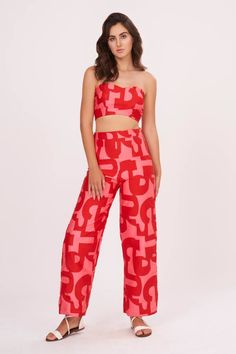 Red cotton satin tube top with abstract print. Comes with palazzo.
Components: 2
Pattern: Printed
Type Of Work: Abstract
Neckline: Tube Neck
Sleeve Type: Sleeveless
Fabric: Cotton Satin
Color: Red
Other Details: 
Attached lining
Closure : Top - Back hooks
Occasion: Party,Resort - Aza Fashions Chic Bold Print Summer Pants, Chic Printed Wide Leg Sets, Red Wide Leg Summer Sets, Red Wide Leg Sets For Summer, Red Wide Leg Sets For Spring, Chic Red Sets For Night Out, Red Sets For Spring Night Out, Red Sets For Night Out In Spring, Chic Red Sets For Spring