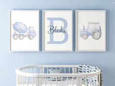 a baby's nursery room with blue walls and white crib, two pictures on the wall