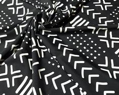 a black and white pattern with dots on the fabric, it looks like an abstract design