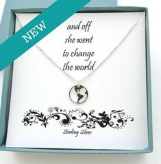 a necklace in a box with a ribbon around it and the words she went to change the world