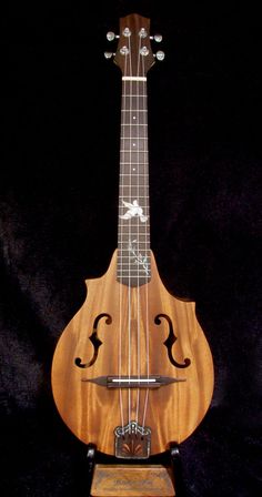 a wooden instrument sitting on top of a black background