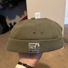 Never Worn Green Brimless Hat. Khaki Flat Cap For Winter, Khaki Winter Flat Cap, Green Flat Cap For Summer, Casual Solid Brimmed Baseball Cap, Casual Brimmed Mini Hat For Winter, Casual Winter Brimmed Mini Hats, Spring Flat Cap Hat, Trendy Khaki Cotton Hat, Solid Spring Flat Cap